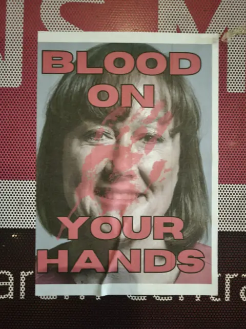 A poster of Jo Stevens is defaced with the words "blood on your hands"