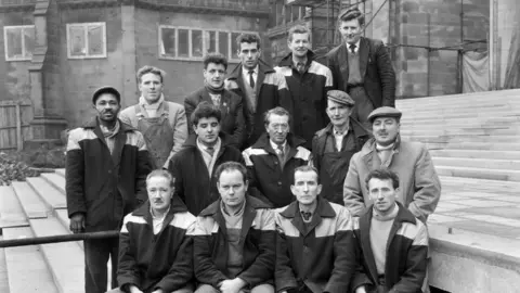 Historic Enlgand/John Laing Collection Group of builders outside cathedral