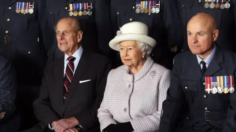 Getty Images Prince Philip and the Queen pose for a photo during a visit to RAF Lossiemouth on their 67th wedding anniversary in 2014