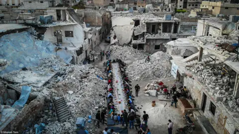 Mouneb Taim Ramadan in the ruins in Idlib, Syria