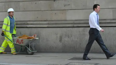 Reuters Construction worker and man in suit