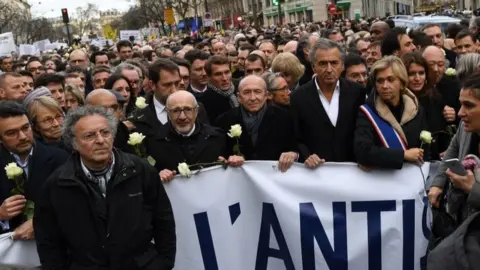 AFP/Getty Images People take part in a silent march in Paris, France. Photo: 28 March 2018