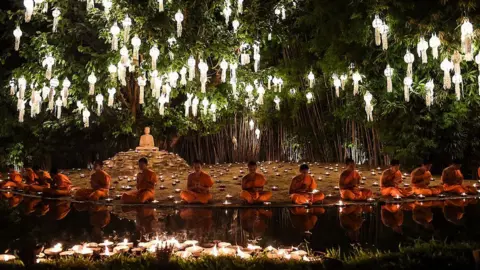 EPA Novice Buddhist monks sit to pray at Wat Phan Tao temple to mark the beginning of the annual Yi Peng festival in the popular tourist city of Chiang Mai in the north of Thailand