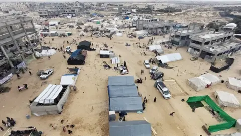 Feras Al-Shaer A photo overlooking Al-Mawasi. People and tents can be seen in the foreground