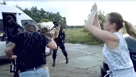Spetsnaz Show Screenshot of Yulia throwing flowers at her husband-to-be