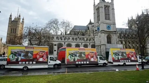 PA Vans carrying billboards protesting at the Crown Prince's visit