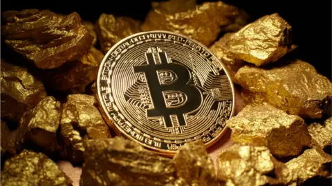 Getty Images A Bitcoin and gold nuggets