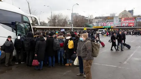 Reuters People trying to leave Kyiv by bus