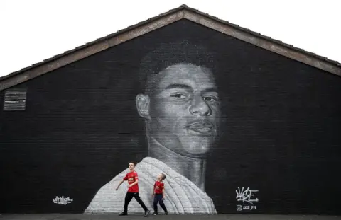 Martin Rickett/PA Media A mural of Manchester United striker Marcus Rashford by Street artist Akse on the wall of the Coffee House Cafe on Copson Street, Withington. 8 November 2020.