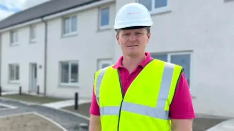 Stephen Kemp in front of houses