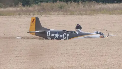 Paul Tolliday/Blue Sky Aerial Services Pilot and Mustang in field