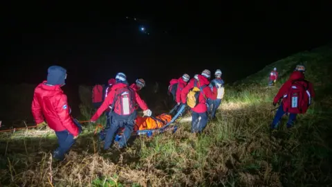 Keswick Mountain Rescue Team Man being stretchered to safety