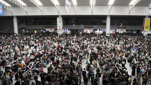 Getty Images Passengers wait for trains at Nanchang Railway Station on the first day of May Day holiday on April 29.