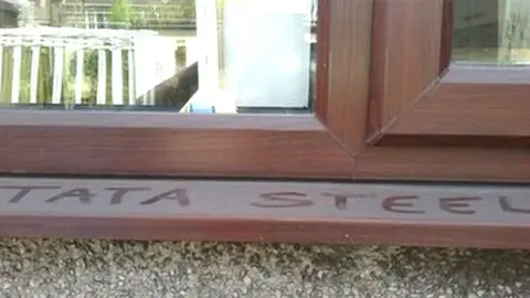 Peter Davies Words Tata Steel written in dust on external window sill at Port Talbot home of Peter Davies