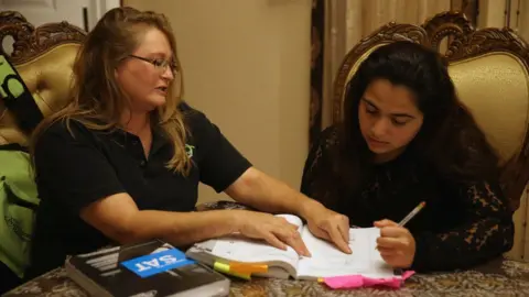 Getty Images A Princeton Review tutor helping a student in Florida