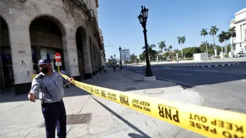 EPA A police officer guards the areas surrounding the Capitol in Havana after anti-government unrest