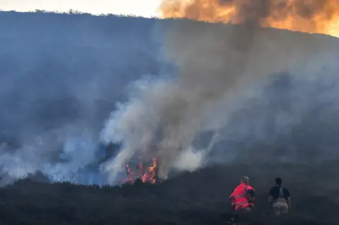 Getty Images Fire crews continue to fight a large wildfire on the moors above Stalybridge