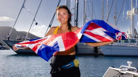 Atlantic Campaigns Atlantic rower Lara Vafiadis holds a Union jack