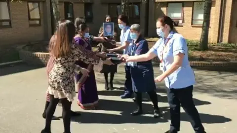 University Hospitals of Leicester NHS Trust Family hands ipads to nurses