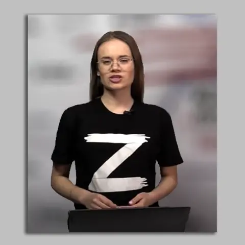 Southern Front Female presenter wearing black t-shirt bearing the letter "Z"