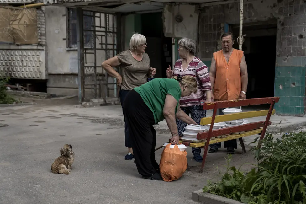 BBC Saltivka residents collect free meals delivered once a day by a food charity. For many, it is there one meal a day now