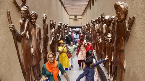 Getty Images Visitors at the Jallianwala Bagh memorial after its reopening, on August 29, 2021 in Amritsar, India.