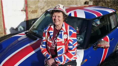 PA Media Anita Atkinson and her union jack decorated car