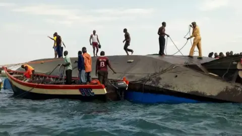 Stephen Msengi Volunteers work at the scene of a capsizing in Tanzania