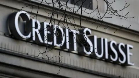 Getty Images Credit Suisse logo with overhanging bare branches in foreground