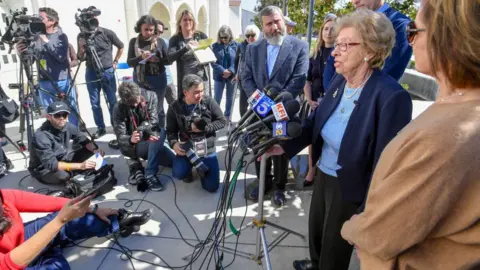 Getty Images Eva Schloss addresses the media at Newport Harbor High School after Schloss meet with students involved in a party with Nazi salutes around a makeshift swastika in Newport Beach