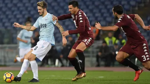 ANDREAS SOLARO Lazio"s Spanish midfielder Luis Alberto vies for the ball with Torino"s Argentinian defender Nicolas Burdisso during match