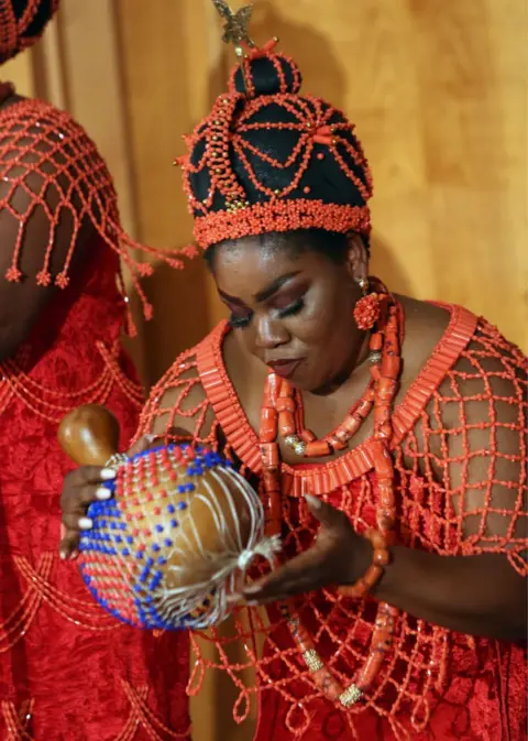 AFP A Nigerian musician plays at a ceremony for the signing of an agreement of intent to return them to Nigeria at the German foreign ministry in Berlin, Germany on July 1, 2022. - Thousands of Benin bronzes, metal plaques and sculptures that once decorated the royal palace of the Kingdom of Benin, are now scattered around European museums after being looted by the British at the end of the 19th century.