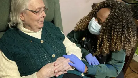 Martin Giles/BBC Leah with patient