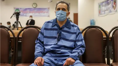 Getty Images Jamshid Sharmahd on trial in Tehran in February 2022