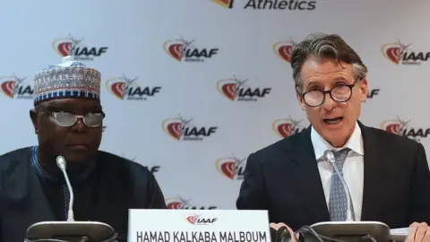 VALERY HACHE Hamad Kalkaba Malboum (left) and IAAF President Lord Coe (right)