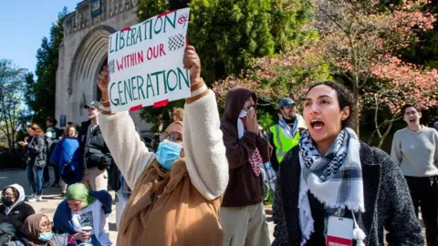 Reuters Protesters against the war in Gaza at Yale University. One is seen holding a sign that reads: "Liberation within our generation".