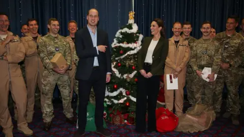 Getty Images The Duke and Duchess of Cambridge standing by a Christmas tree at RAF Akrotiri base