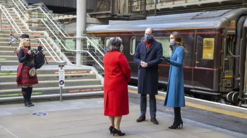 PA Media Kate and William are greeted by a piper in Edinburgh