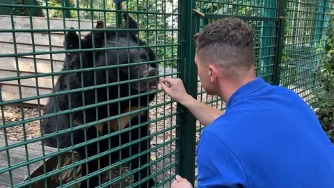 Five Sisters Zoo Yampil the Asiatic Black Bear and Zoo worker