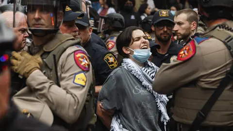 Police detain a demonstrator during a pro-Palestinian protest at the University of Texas (UT) in Austin, Texas, US, on Wednesday, April 24, 2024