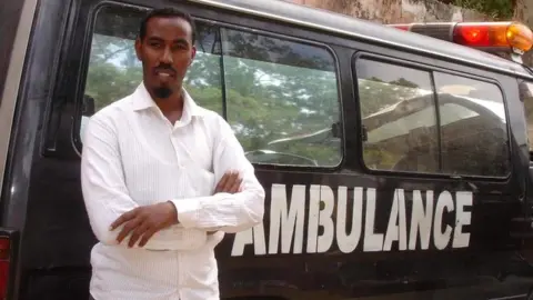 Abdulkadir Abdirahman Adan Abdulkadir Abdirahman Adan standing against an ambulance