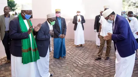 BBC Tanzania's Prime Minister Kaasim Majaaliwa being greeted outside the mosque