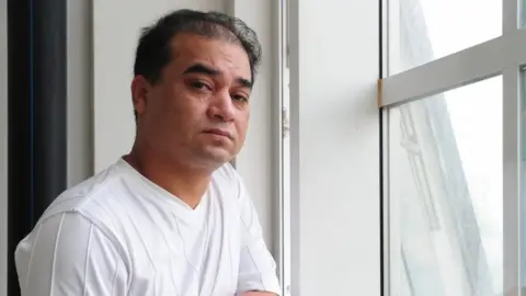 Getty Images Ilham Tohti, an economics scholar, has been an outspoken critic of China's treatment of the Uighur minority