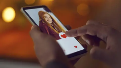 Getty Images Person tapping on a phone screen