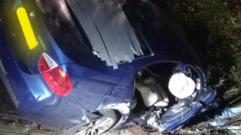 Newton Abbot Fire Station  An overturned car in Kingsteignton