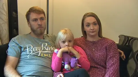 Parents James and Ellie Mason at home with their daughter Rosie-May