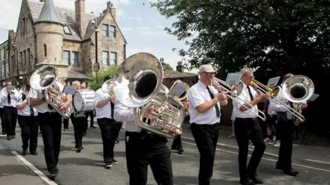 Stacksteads Brass Band in a carnival parade