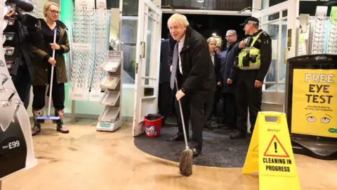 AFP Prime Minister Boris Johnson helping with the clean up in Matlock on Friday evening