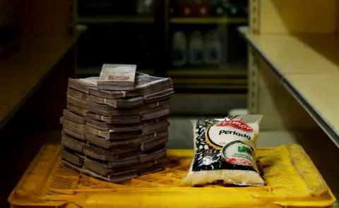 Reuters A package of 1kg of rice next to 2,500,000 bolivars