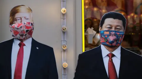 Reuters Cardboard cutouts of U.S. President Donald Trump and Chinese President Xi Jinping, with protective masks widely used as a preventive measure against coronavirus disease (COVID-19), near a gift shop in Moscow, Russia